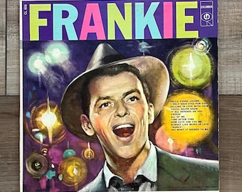 Può includere: Copertina di un album in vinile vintage con il nome "FRANKIE" in grandi lettere colorate. L'artwork presenta un ritratto di un uomo con un cappello, con i titoli delle canzoni. Il logo Columbia Records è visibile.