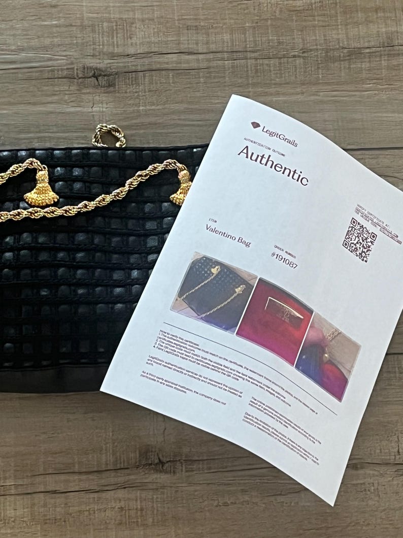 May include: A black textured handbag with a gold-tone rope chain strap and tassel accents, accompanied by a LegitGrails authentication certificate labeled Authentic for a Valentino Bag with order number 191087 and a QR code for verification.