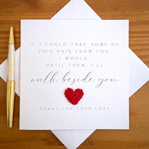 May include: A white sympathy card with the message "If I could take some of this pain from you, I would. Until then, I'll walk beside you. Sorry for your loss." A red heart is attached to the card.