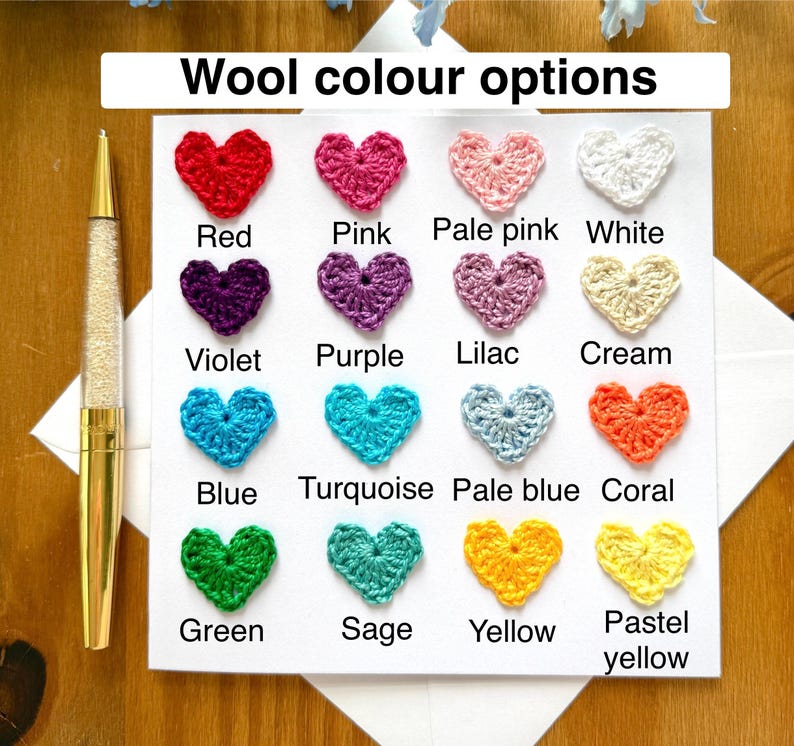 Puede incluir: Una tarjeta con una tabla de corazones tejidos a crochet en varios colores, incluyendo rojo, rosa, rosa p&aacute;lido, blanco, violeta, morado, lila, crema, azul, turquesa, azul p&aacute;lido, coral, verde, salvia, amarillo y amarillo pastel. El texto "Wool color options" est&aacute; en la parte superior de la tarjeta.