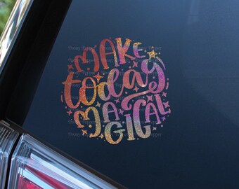 May include: A car with a sticker on the back window that says "Make today magical" in a rainbow gradient font.