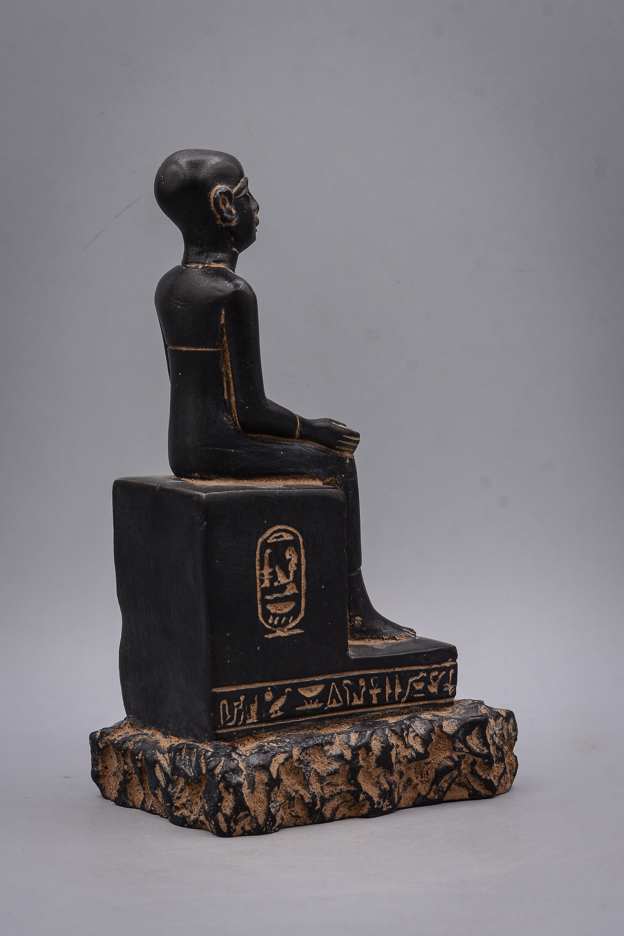 Statue of Egyptian art Seated statue of Imhotep holding an open papyrus