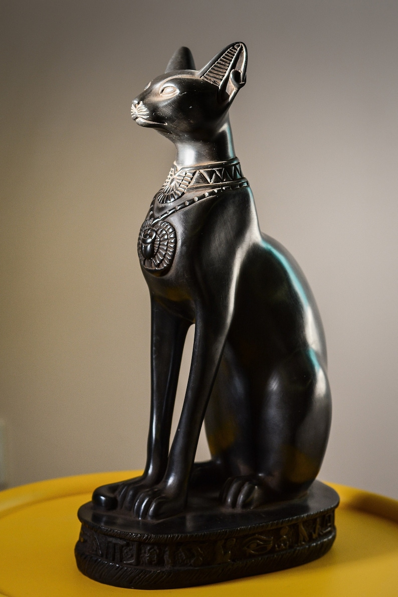 unique goddess Bastet cat large statue black with scarab on her chest, symbols hieroglyphic inscriptions around the base made in Egypt 