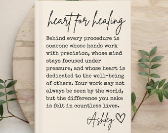 May include: A rectangular cream-colored sign with black text that reads: heart for healing. Behind every procedure is someone whose hands work with precision, whose mind stays focused under pressure, and whose heart is dedicated to the well-being of others. Your work may not always be seen by the world, but the difference you make is felt in countless lives. Ashley with a heart symbol.