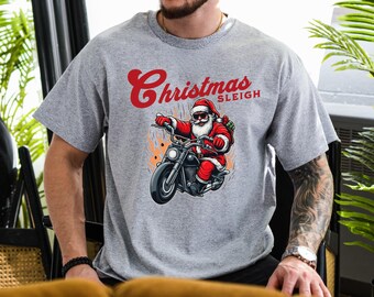 May include: A gray t-shirt with a graphic of Santa Claus riding a motorcycle with the text "Christmas Sleigh" printed on the front.