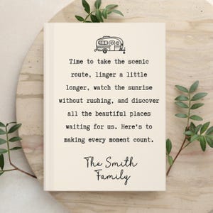 May include: A cream-colored book cover featuring a black line drawing of a camper trailer at the top. The text reads: Time to take the scenic route, linger a little longer, watch the sunrise without rushing, and discover all the beautiful places waiting for us. Here's to making every moment count. The Smith Family.