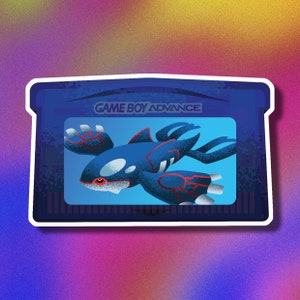 May include: A blue Game Boy Advance cartridge with a blue and red Pokemon character on the front. The cartridge has the text "GAME BOY ADVANCE" printed on the top.