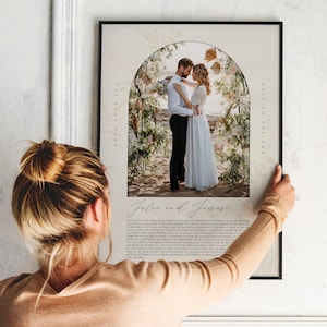 May include: A wedding photo print with a floral archway and the text "True love is the joy of your life" and "Jolie and James" printed below the photo.