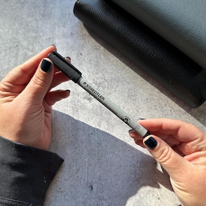 May include: A black and gray marker pen with the text "STAEDTLER Lumocolor permanent marker" printed on the side.