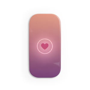 May include: A rectangular wireless charger with rounded corners. The charger has a gradient design, transitioning from peach to purple. A pink heart is centered within a glowing circle.