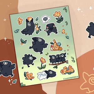 May include: A sheet of stickers featuring black crows in various poses, including a crow with a flower in its beak, a crow with a knife, and a crow with a speech bubble that says "Gawk". The stickers are on a green background with yellow flowers and leaves.