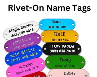 May include: Assortment of colorful oval-shaped metal name tags with black text and phone numbers. The tags are 51 mm long and 19 mm wide. The tags are for pets and feature names like Magic Merlin, Little LuLu, Wild Willie, Pebbles, Little Man Louie, Dakota, Tiger, Leroy Brown, and Lucky.