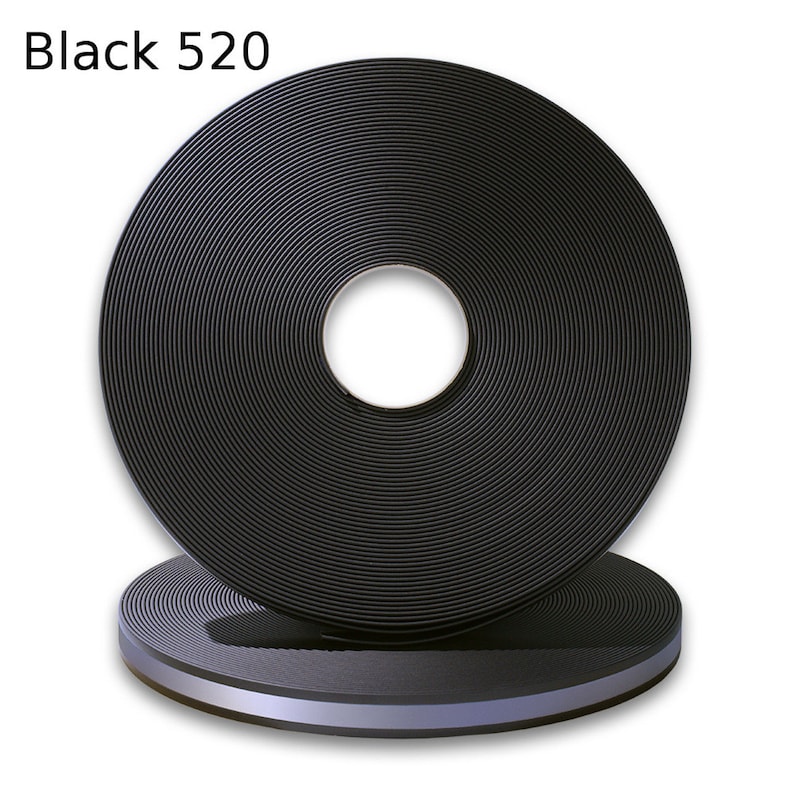 May include: A roll of black 520 webbing with a silver reflective stripe. The webbing is rolled up and the silver stripe is visible on the edge.