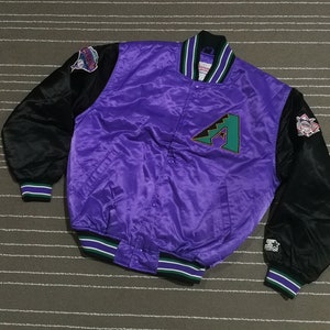 May include: A purple and black satin baseball jacket with the Arizona Diamondbacks logo on the front. The jacket has green and white stripes on the collar, cuffs, and hem.