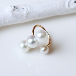 May include: Gold ear cuff with three white pearls, 4-5 mm in size. The ear cuff is labeled "K18YG ear cuff" and "Rare baby pearl 3-piece type".