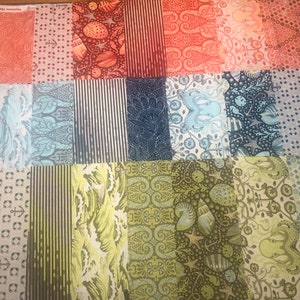 May include: A collection of 20 fabric squares featuring a variety of sea-themed patterns in shades of blue, green, and brown. The patterns include anchors, waves, seashells, and fish.