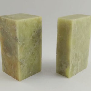 May include: Two rectangular green stone blocks, one slightly larger than the other. The blocks have a rough, textured surface and a light green colour with brown streaks.