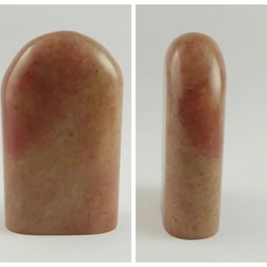 May include: A red and brown stone seal with a rounded top and a rectangular base.