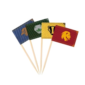 May include: Set of four decorative flag toothpicks. Each flag features a different house crest: a lion, badger, snake, and eagle. The flags are red, gold, green, and blue with wooden sticks.