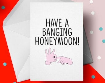Peut inclure: Une carte blanche avec du texte noir qui dit "Have a Banging Honeymoon!" avec une illustration de geste de la main rose.