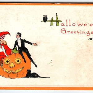 Halloween Postkarte Bergman Mann Frauen sitzen auf riesigen Kürbis JOL schwarze Katze 1912