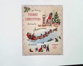 May include: Vintage Christmas card with a festive design. The card features illustrations of Santa's sleigh, a decorated Christmas tree, and a family scene. Text includes "Merry Christmas" and "Santa's Sleigh."