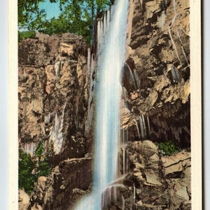 May include: Vintage postcard featuring Chief Benge Falls near Bristol, VA.-Tenn. The image showcases a waterfall cascading down a rocky cliff face. The water is a bright white, contrasting with the brown and gray rocks. Green trees are visible at the top.