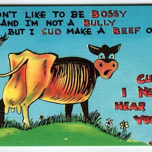 May include: A vintage postcard featuring a cartoon cow. The cow is depicted in black and brown with a yellow udder, standing on green grass. The card includes text: "I don't like to be bossy..." and "Cuz I never hear from you."
