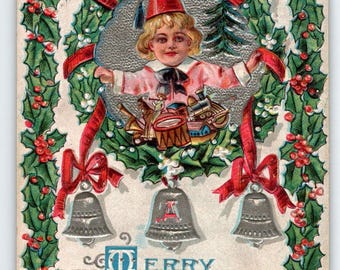 Christmas Postcard Child In Fez Hat Embossed Silver Bells Poinsettia Lions Head
