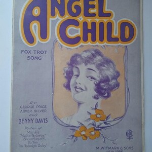 May include: Vintage sheet music cover titled "Angel Child." The title is in large purple letters with a yellow outline. The cover features an illustration of a woman with purple hair and a floral design. The text includes the names of the songwriters and publisher.