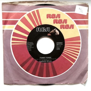 May include: A vintage 45 RPM vinyl record of the song "Funky Town" by Pseudo Echo. The record label is black with a yellow and red radial design and the RCA logo. The record is in a paper sleeve with a purple and red design.