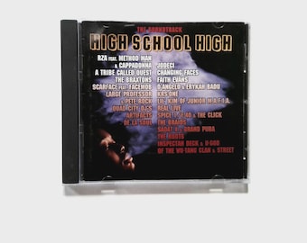 May include: A CD case for the "High School High" soundtrack. The cover is dark with gold lettering for the title. The tracklist includes artists such as RZA, Method Man, A Tribe Called Quest, and more. The CD is housed in a clear plastic jewel case.