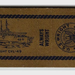 May include: A vintage matchbox with a brown background and navy blue rope border. The matchbox features a navy blue illustration of a ship, the text "U.S.S. WRIGHT CVL-49", and the words "ALWAYS WRIGHT".