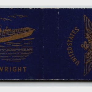 May include: A vintage matchbook with a navy blue background. The left side features a gold illustration of a ship labeled "U.S.S. WRIGHT." The right side displays a gold emblem with the text "UNITED STATES NAVY."