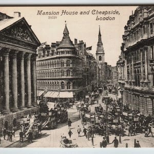May include: Vintage black and white postcard depicting Mansion House and Cheapside in London. The image shows a bustling street scene with horse-drawn carriages, buildings, and pedestrians. The postcard has the text "Mansion House and Cheapside, London" and the number "20510".