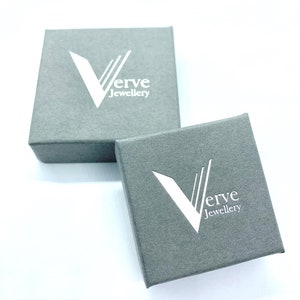 May include: Two gray boxes with the logo "Verve Jewellery" printed in white on the top of each box.