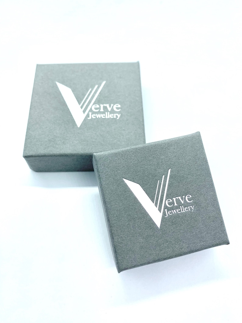 May include: Two gray boxes with the logo "Verve Jewellery" printed in white on the top of each box.