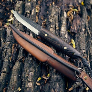 The puukko, n690 steel, wenge, leather sheath, full tang, hand made.