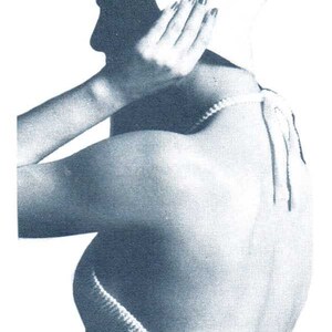 May include: A white crocheted halter top with a tie closure at the back. The top is worn with a white sun hat and blue jeans.