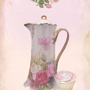 May include: A white porcelain teapot with gold accents and floral designs, including pink and white roses. A pink and white cupcake sits next to the teapot.