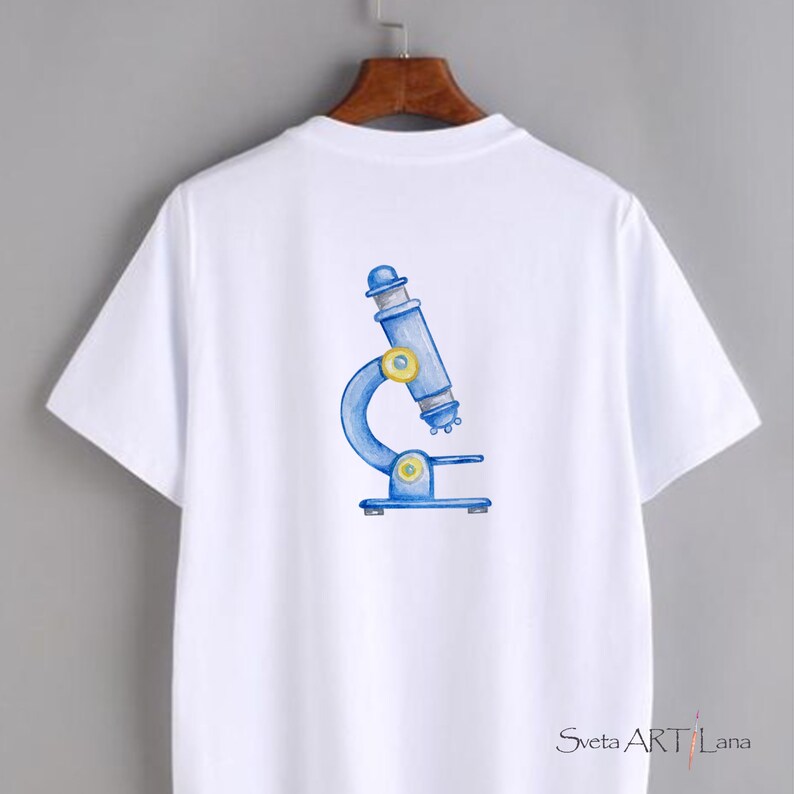 May include: White t-shirt featuring a blue and yellow watercolor illustration of a microscope. The design is centered on the back of the shirt. The shirt has short sleeves and a crew neck.