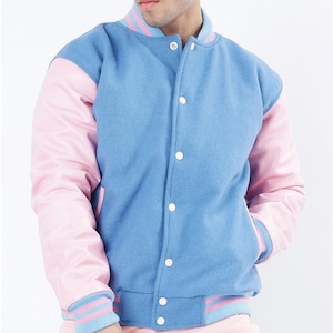 May include: A blue and pink varsity jacket with white buttons and striped cuffs. The jacket is made of a soft, comfortable material and has a classic varsity style.