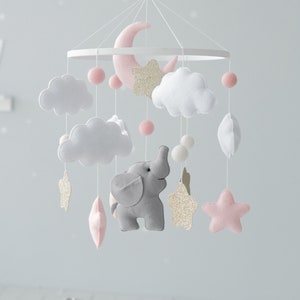 Adorn your baby girl nursery with our Elephant Baby Mobile, showcasing sweet pink hues and golden glitter stars for a touch of elegance and whimsy