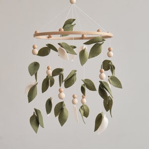 Elegant felt olive leaf baby mobile with wooden accents, inspired by the serenity of the forest, perfect for a nature-themed nursery. This baby crib mobile will perfectly match to your boho neutral nursery.