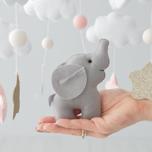 Elevate your nursery decor with our Baby mobile girl, adorned in precious pink tones and golden glitter stars to add a touch of glamour to your elephant nursery
