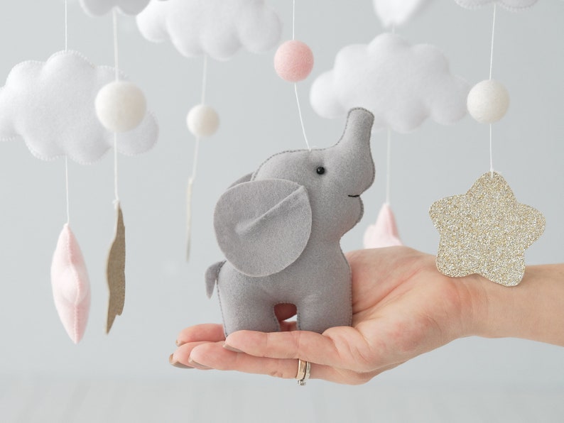 Elevate your nursery decor with our Baby mobile girl, adorned in precious pink tones and golden glitter stars to add a touch of glamour to your elephant nursery