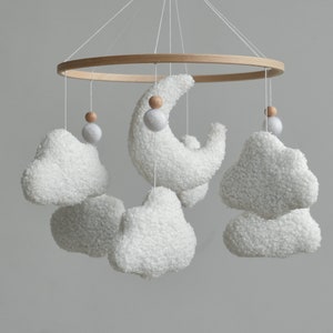 Soft and cozy cloud nursery decor with boucle clouds and moon will be a wonderful addition to your baby room. This cloud mobile is also a memorable and thoughtful baby shower gift and gift newborn.