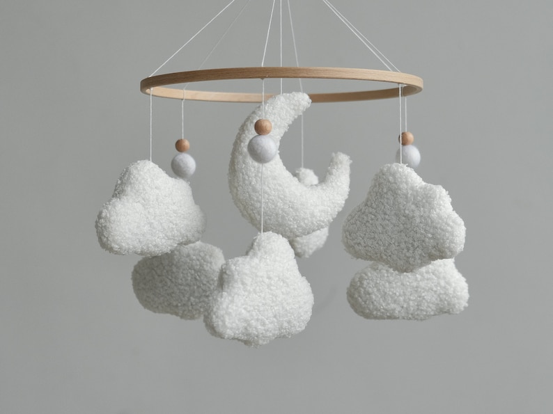 Soft and cozy cloud nursery decor with boucle clouds and moon will be a wonderful addition to your baby room. This cloud mobile is also a memorable and thoughtful baby shower gift and gift newborn.