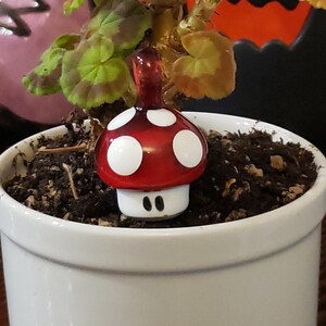 Super Mario inspired glass power up mushroom pendant.