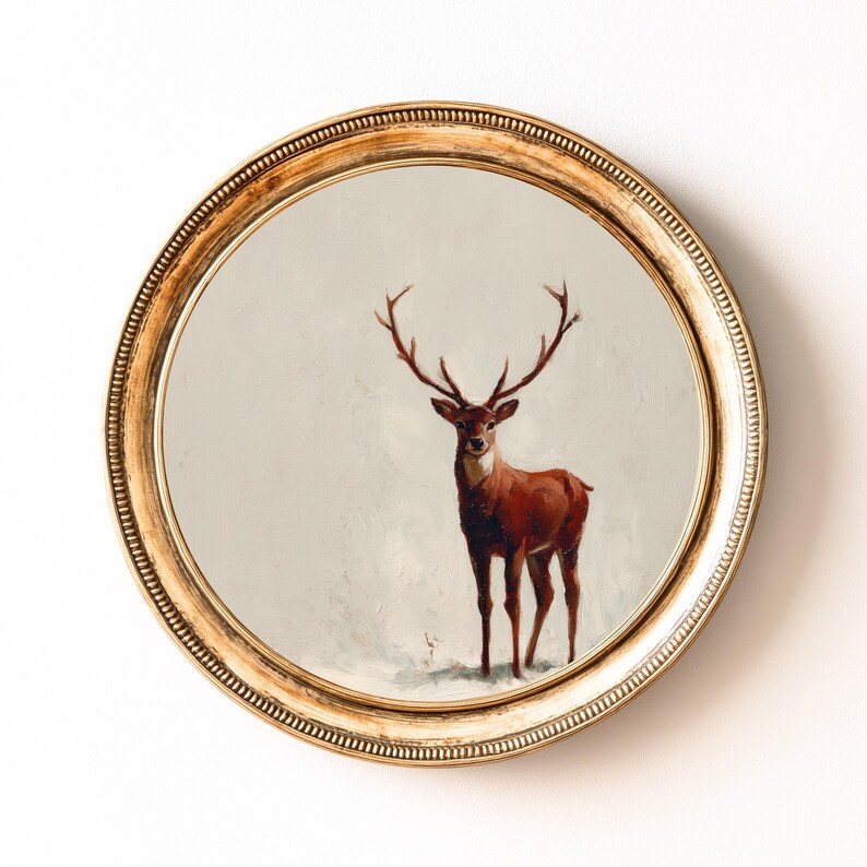 May include: A round wall art piece featuring a painting of a deer with large antlers. The deer is painted in shades of brown and red against a neutral background. The artwork is framed in a gold, ornate, circular frame.
